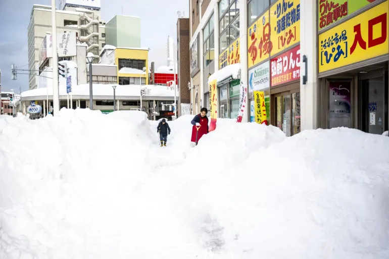 Japan’s snow emergency turns deadly as record drifts bury towns
